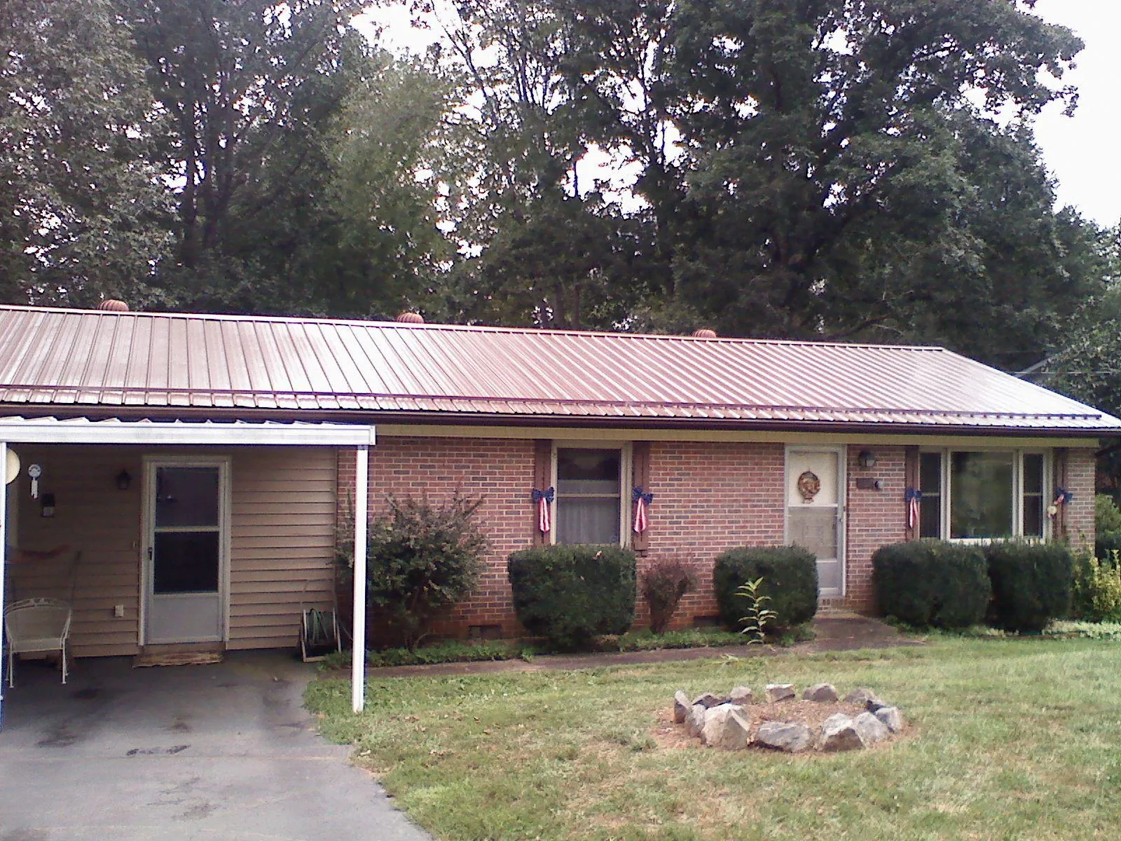 Bronze metal roof and carport on a brick ranch home — Roof Repair work by our crew in Clifton Heights